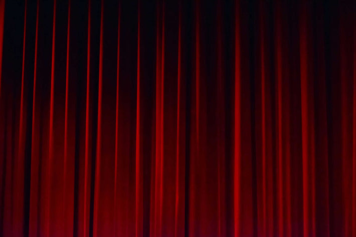 A closed velvet theatre curtain.